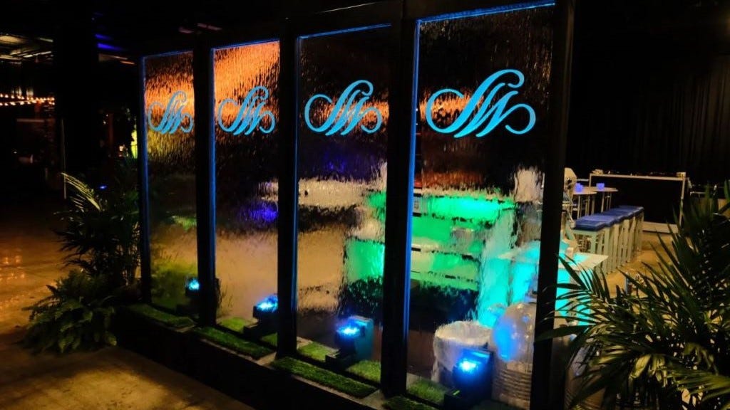 Water Wall with Custom Graphic Logo at Night