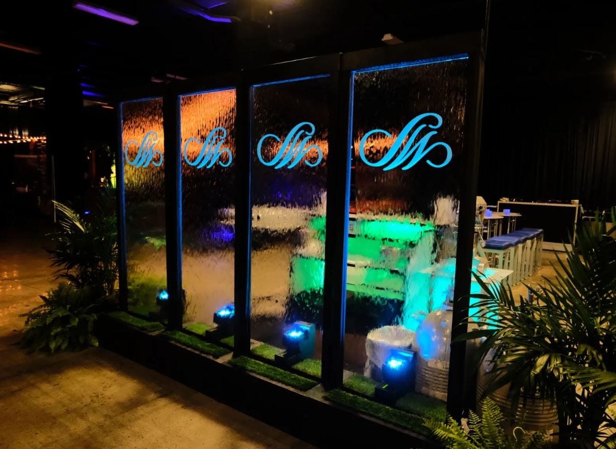 Water Wall with Custom Graphic Logo at Night